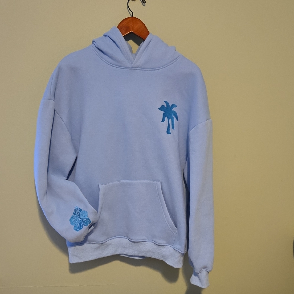 Pink Palm Puff "Everything Comes In Waves" light blue hoodie.